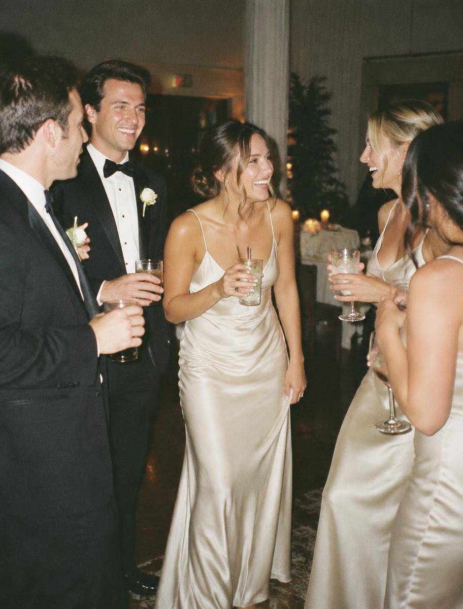 A group of guests mid-conversation, laughing together